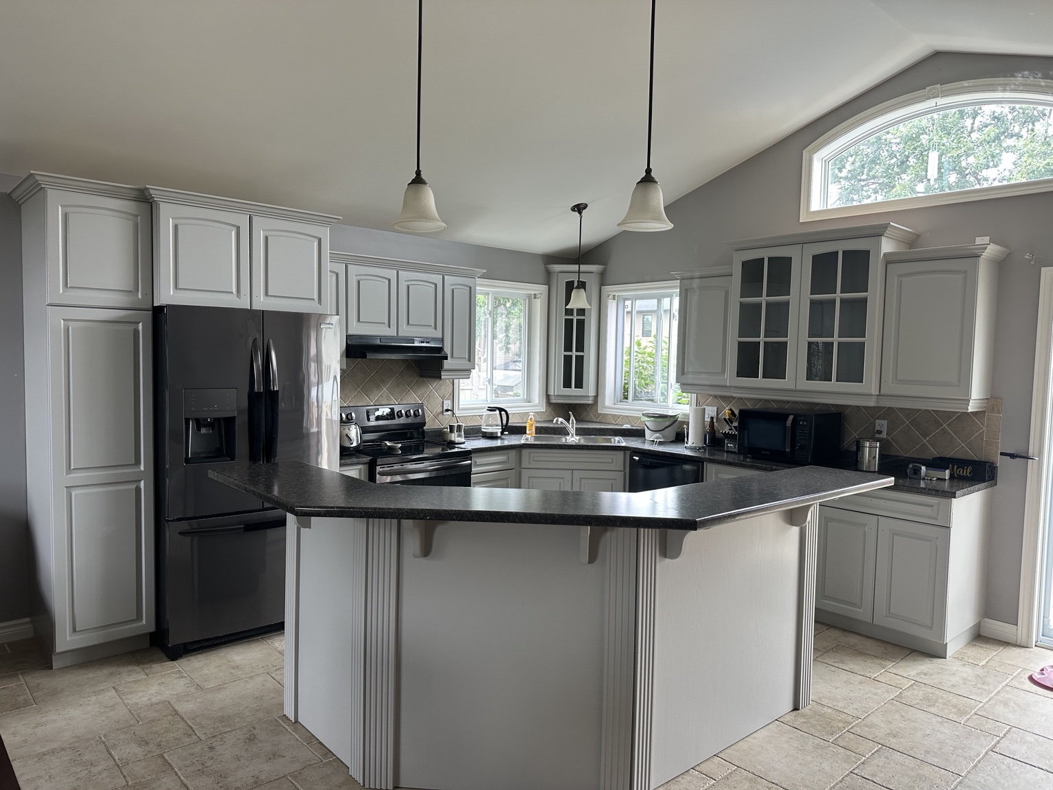 Grey kitchen cabinets after professional refinishing