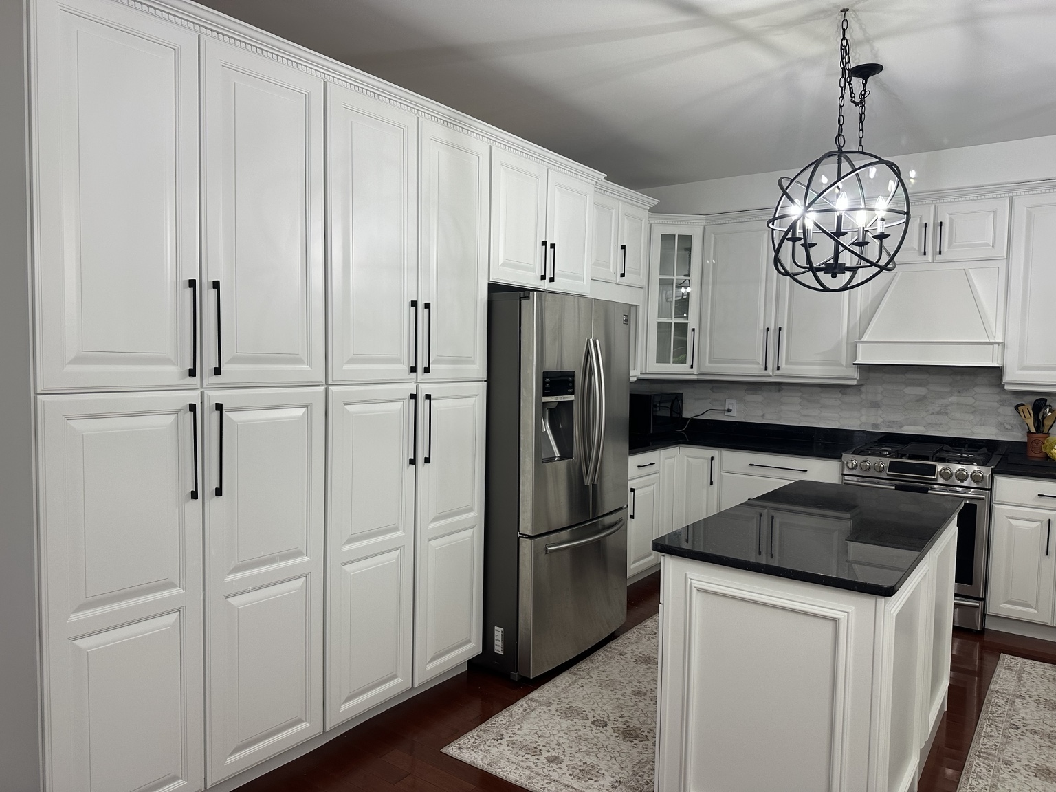 White kitchen cabinets after professional refinishing
