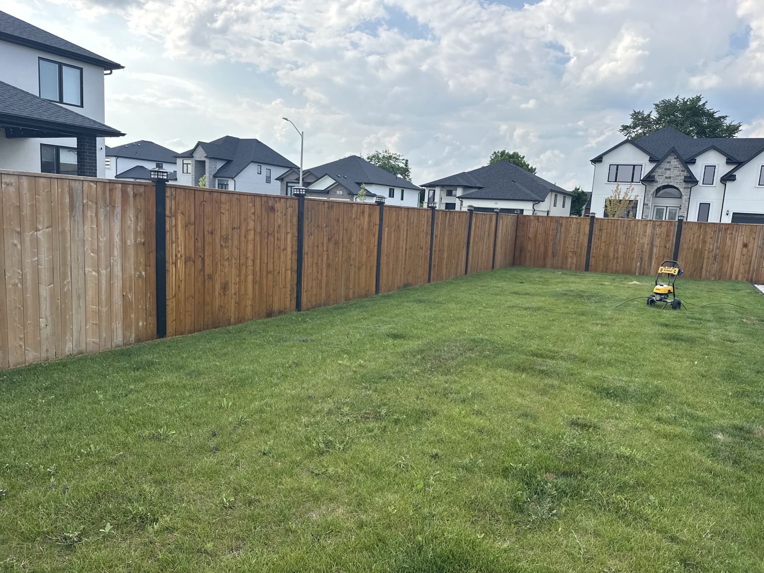 Natural wood backyard fence before staining