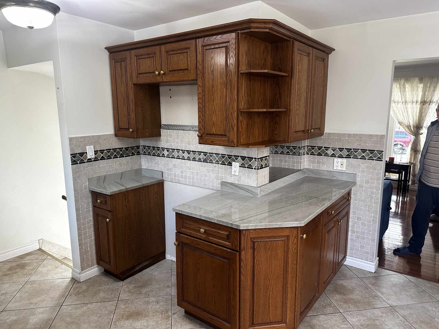 Wood kitchen island and cabinets before refinishing