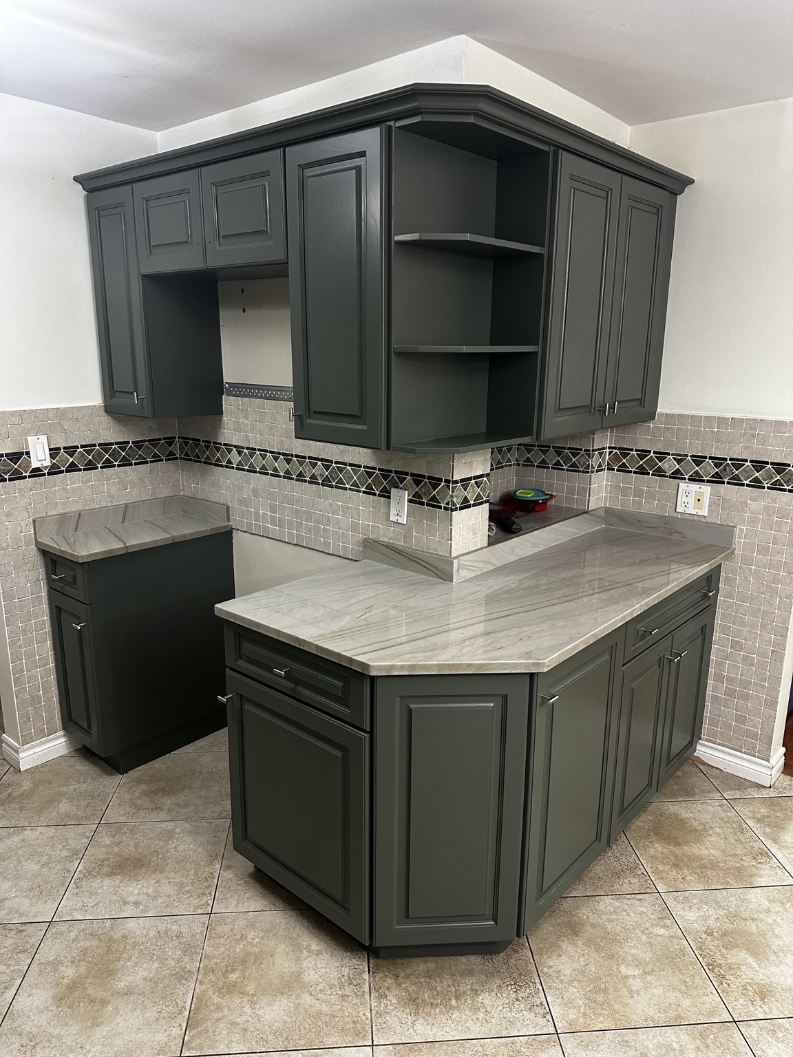 Grey kitchen island and cabinets after refinishing
