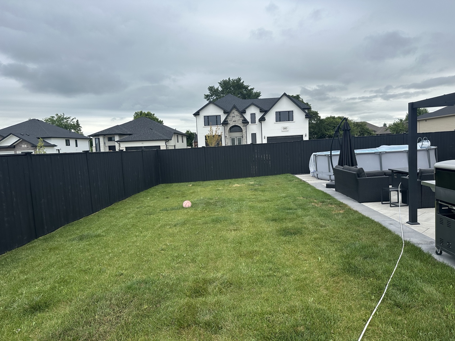 Backyard fence after charcoal staining