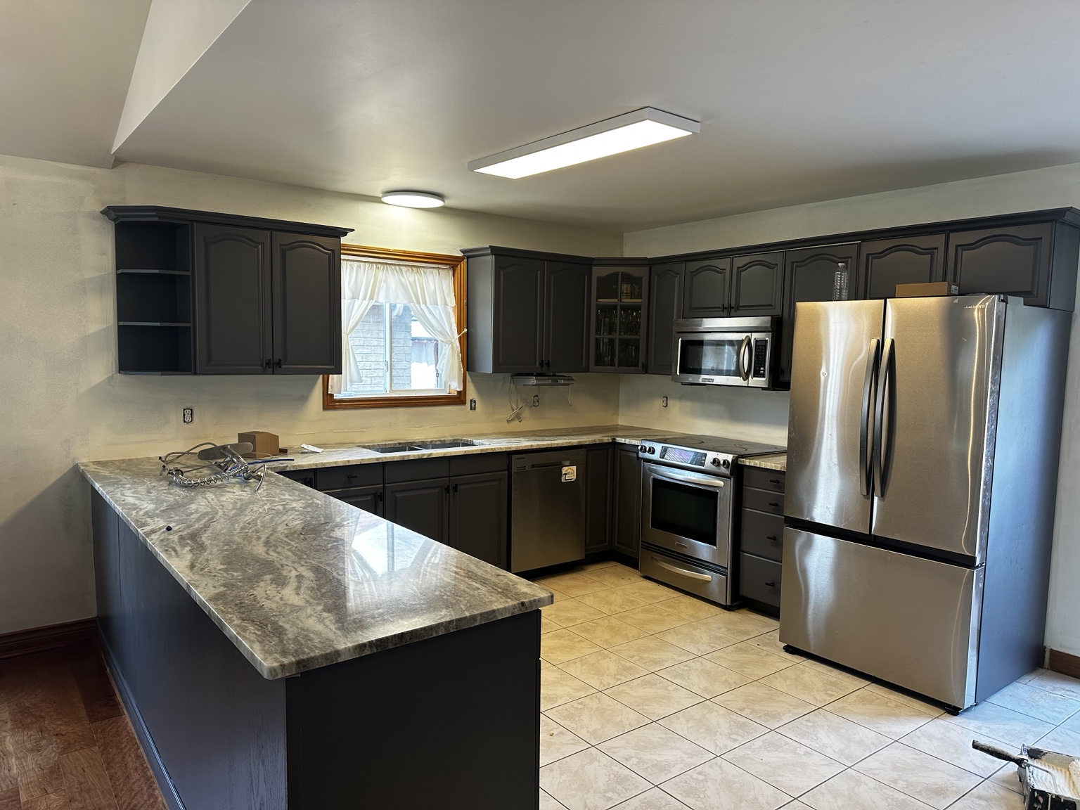 Charcoal grey kitchen with island after refinishing