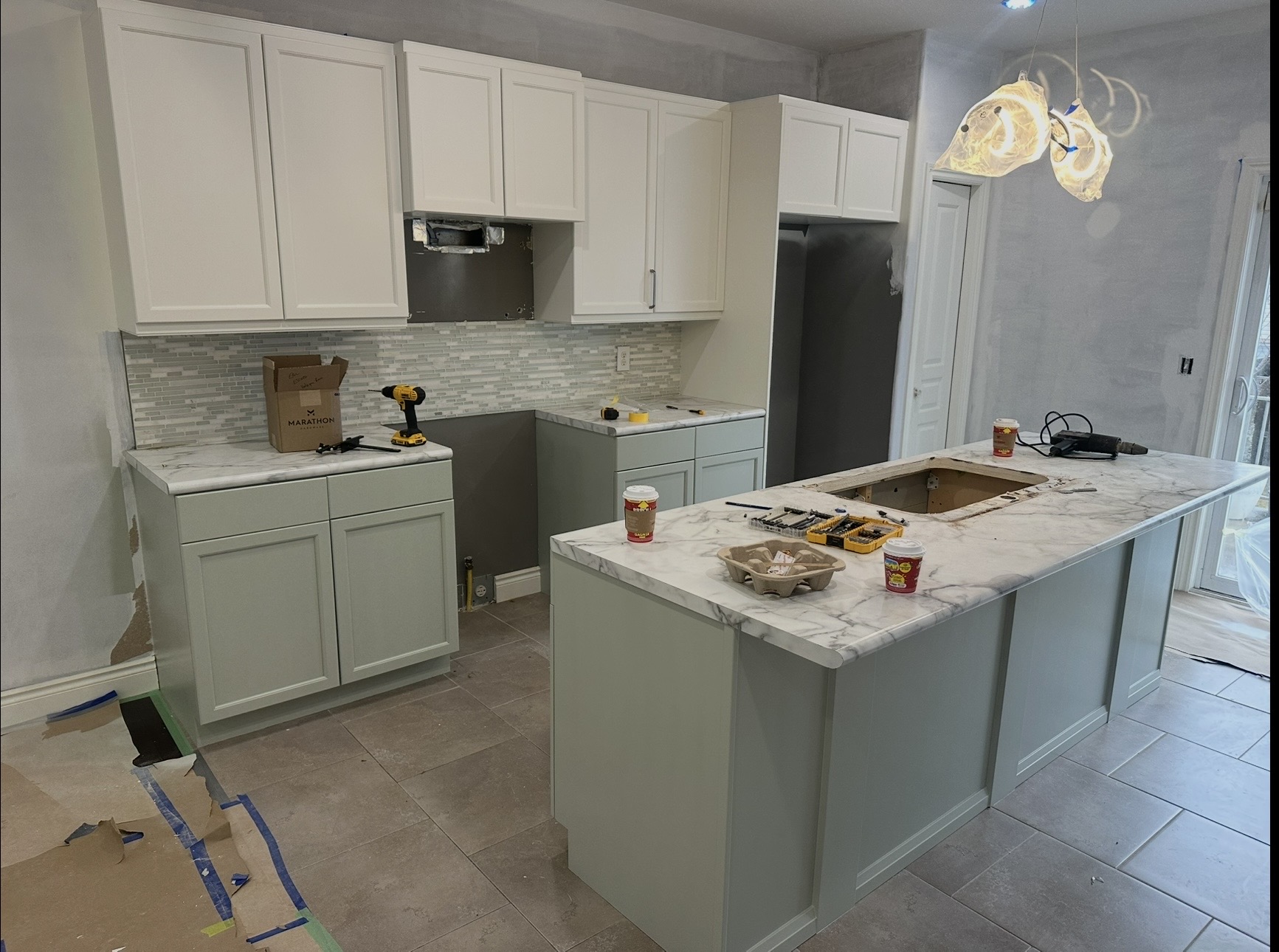 White and soft green two-tone kitchen cabinets