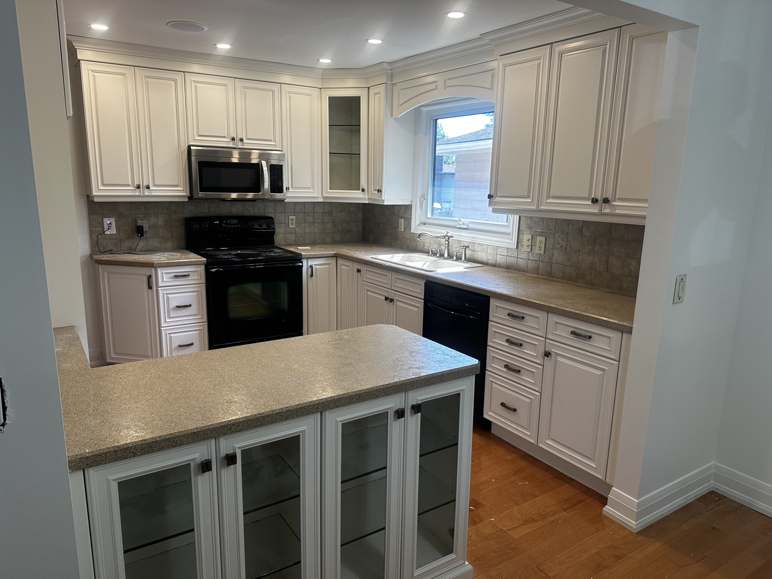 Professionally refinished white kitchen cabinets